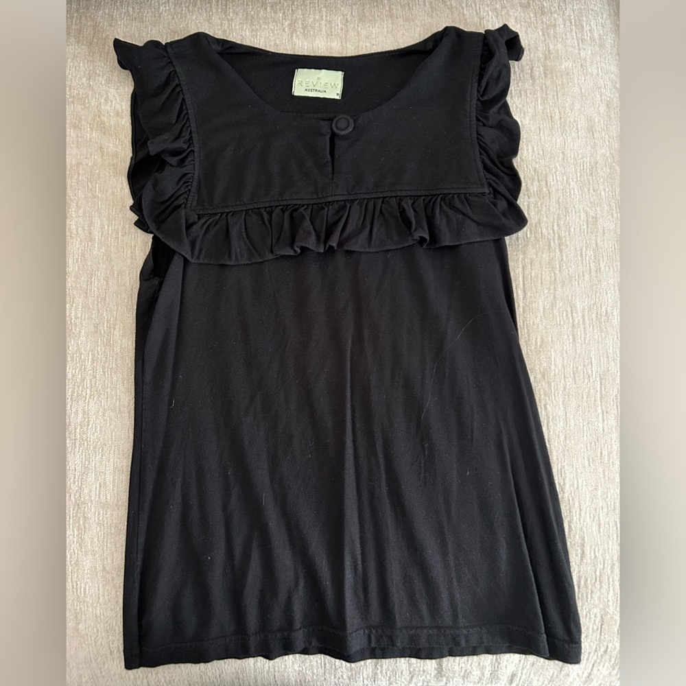 Black sleeveless blouse with frill trim